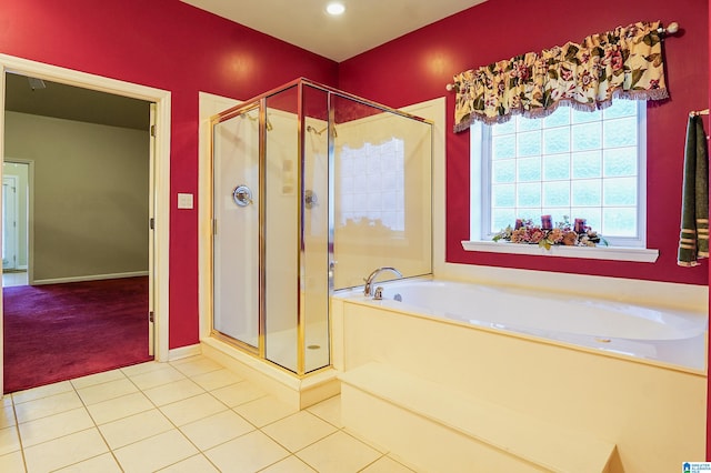 bathroom with tile patterned floors and shower with separate bathtub