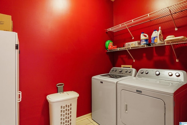 clothes washing area featuring independent washer and dryer and light tile patterned floors