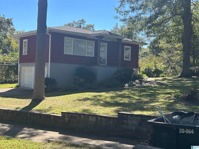 view of front of property with a front yard and a garage