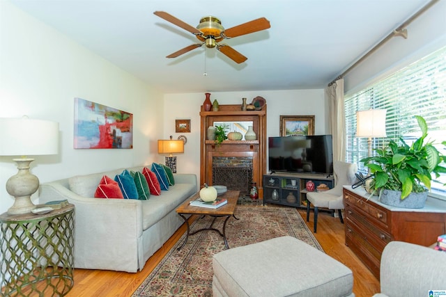 living room with ceiling fan and light wood-type flooring