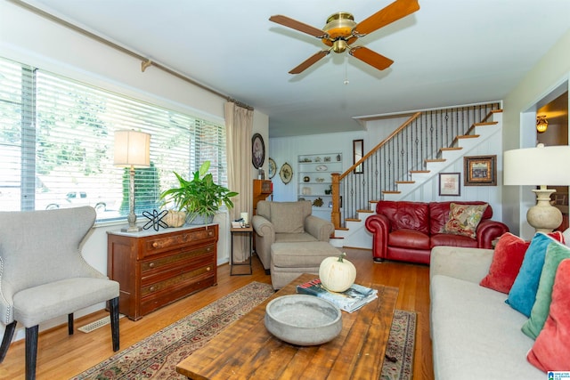 living room featuring light wood-type flooring and ceiling fan