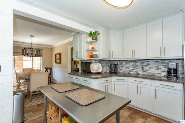 kitchen featuring white cabinetry, decorative light fixtures, and light wood-type flooring