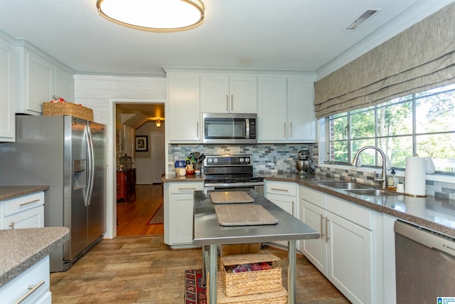 kitchen with white cabinetry, stainless steel appliances, and sink