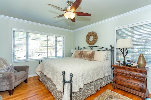 bedroom with crown molding, light wood-type flooring, and ceiling fan