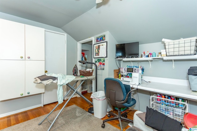 office with lofted ceiling and hardwood / wood-style flooring