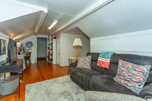 living room featuring hardwood / wood-style floors and lofted ceiling with beams