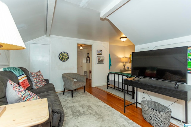 living room with lofted ceiling with beams and hardwood / wood-style flooring