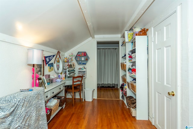 bedroom featuring vaulted ceiling with beams and hardwood / wood-style floors