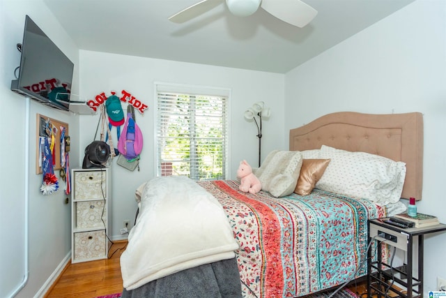 bedroom with hardwood / wood-style floors and ceiling fan