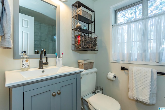 bathroom featuring toilet and vanity