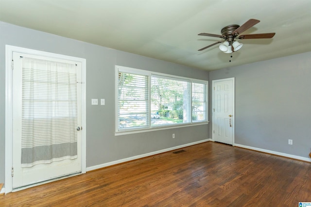 empty room with dark hardwood / wood-style floors and ceiling fan