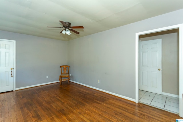 unfurnished room featuring dark hardwood / wood-style floors and ceiling fan