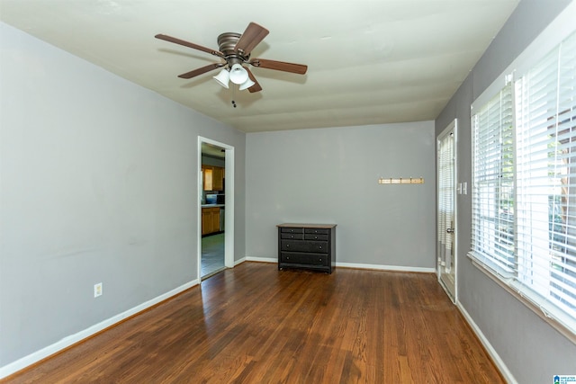 unfurnished room featuring dark hardwood / wood-style floors, a healthy amount of sunlight, and ceiling fan