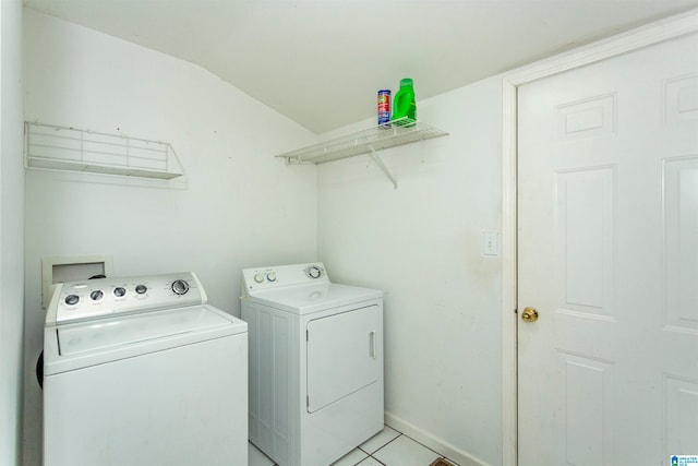 laundry room with separate washer and dryer and light tile patterned floors