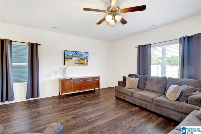 living room with ceiling fan and dark hardwood / wood-style flooring