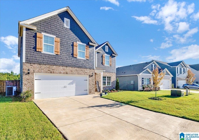 view of front of property with a front lawn, central AC unit, and a garage