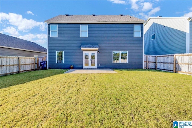 rear view of property featuring french doors, a yard, and a patio