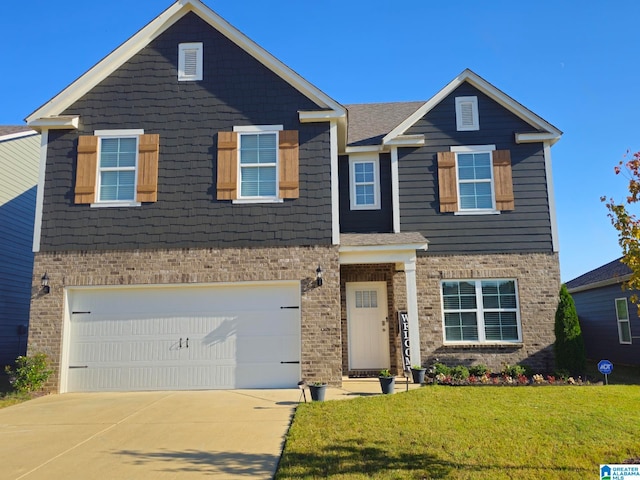 view of front facade with a front yard and a garage