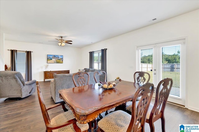 dining area with french doors, ceiling fan, dark wood-type flooring, and a wealth of natural light