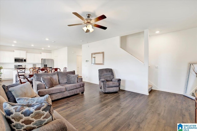 living room featuring dark hardwood / wood-style floors and ceiling fan