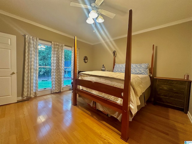 bedroom with ceiling fan, crown molding, and hardwood / wood-style floors