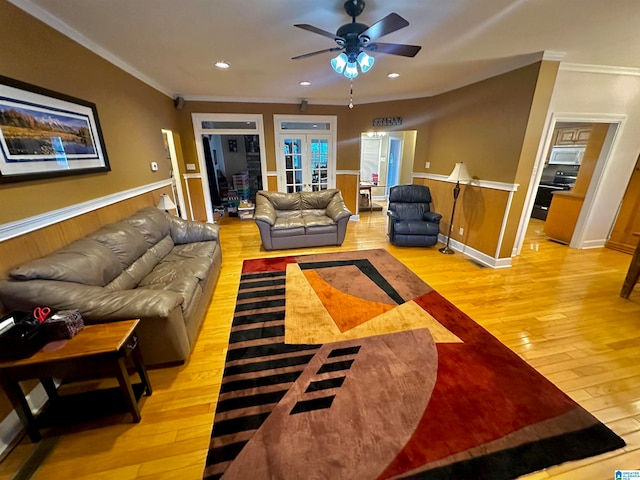 living room featuring french doors, light hardwood / wood-style flooring, crown molding, and ceiling fan