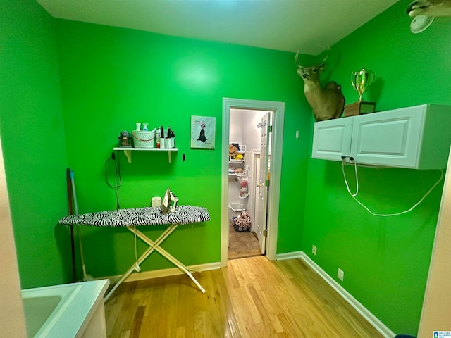 laundry room with light hardwood / wood-style flooring