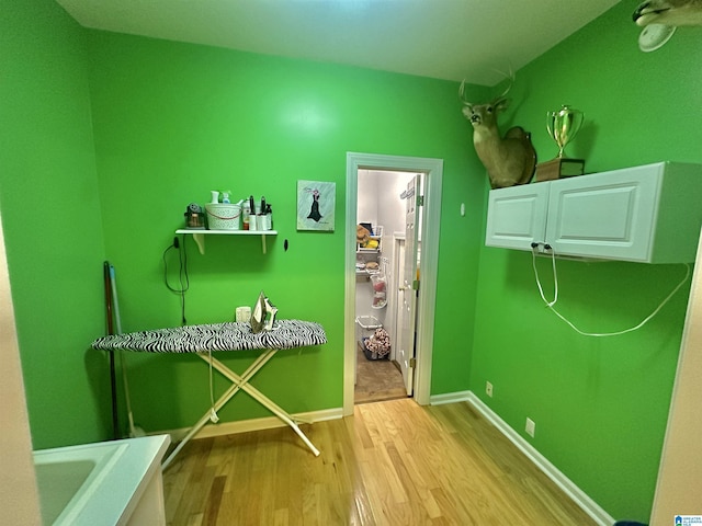 46 Stone Ridge Dr, Sylacauga, AL 35150 - laundry area featuring wood finished floors and baseboards