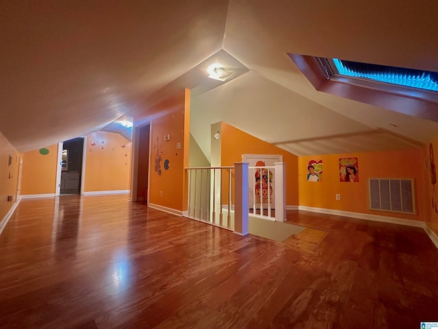 additional living space with lofted ceiling and hardwood / wood-style floors