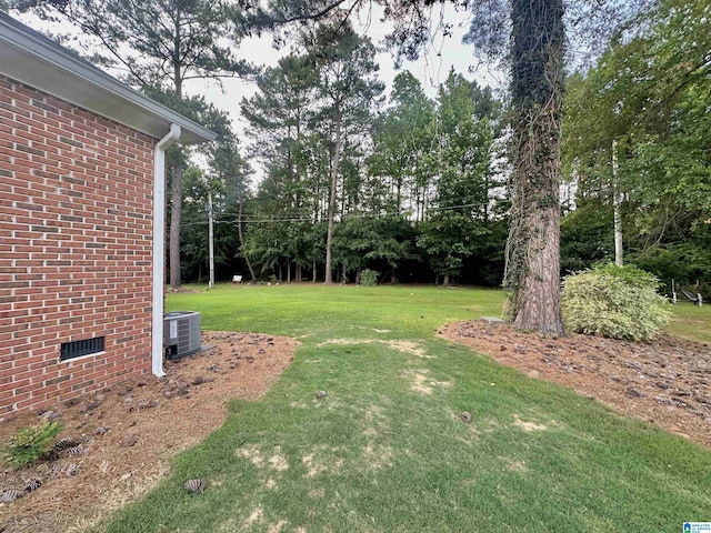 46 Stone Ridge Dr, Sylacauga, AL 35150 - view of grassy yard with central AC and view of wooded area
