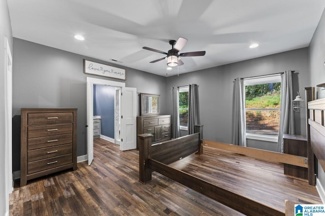 bedroom featuring dark hardwood / wood-style flooring, connected bathroom, and ceiling fan