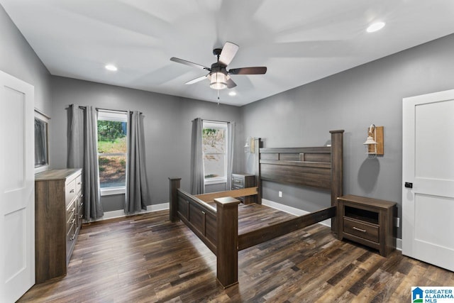 bedroom with ceiling fan and dark hardwood / wood-style flooring