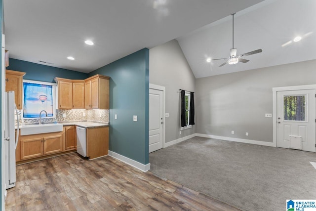 kitchen featuring ceiling fan, backsplash, hardwood / wood-style flooring, sink, and white appliances