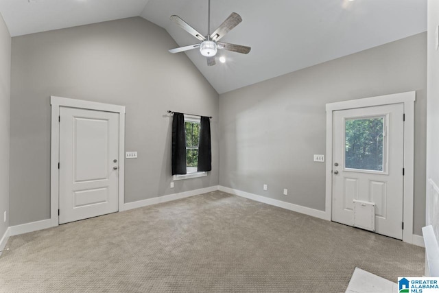 entrance foyer with light colored carpet, high vaulted ceiling, and ceiling fan