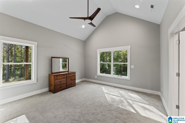 unfurnished bedroom with ceiling fan, high vaulted ceiling, and light colored carpet