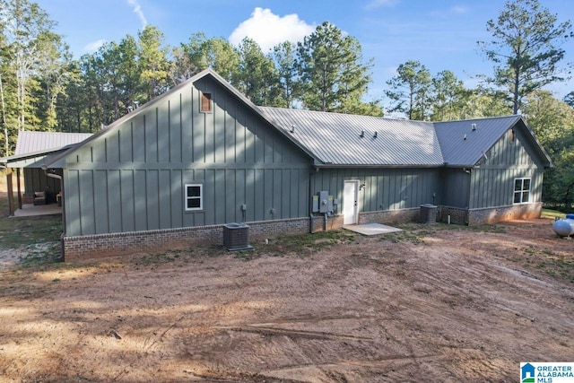 rear view of property featuring central AC