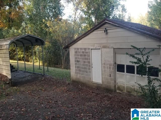 view of outbuilding with a garage and a carport