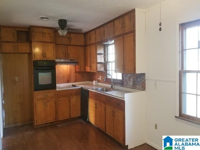 kitchen featuring dark hardwood / wood-style flooring, sink, oven, white stovetop, and ceiling fan