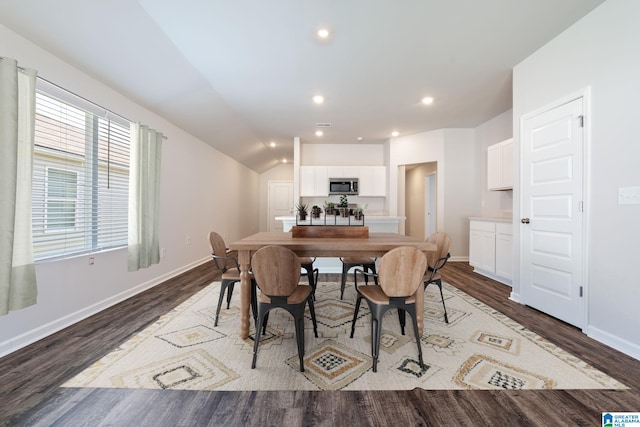 dining area featuring hardwood / wood-style floors and lofted ceiling