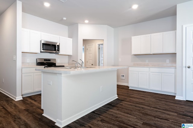 kitchen featuring white cabinets, stainless steel appliances, and a kitchen island with sink