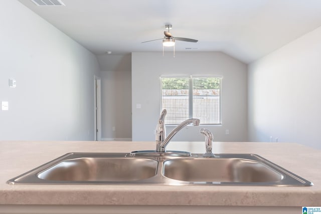 kitchen with ceiling fan, lofted ceiling, and sink