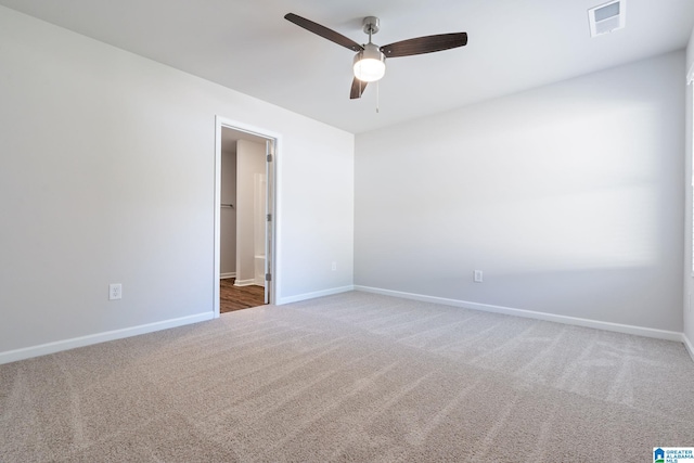 spare room featuring ceiling fan and carpet floors