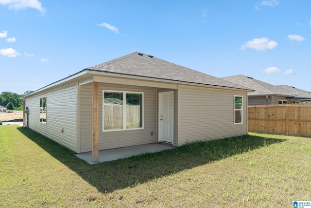 rear view of house with a yard and a patio area