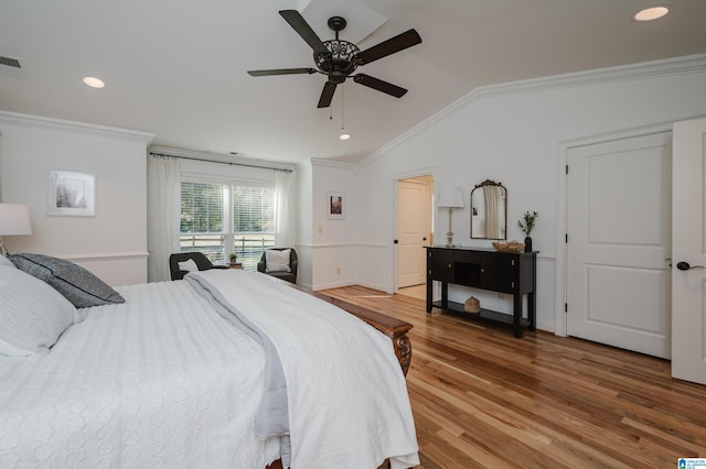 bedroom featuring crown molding, vaulted ceiling, hardwood / wood-style flooring, and ceiling fan