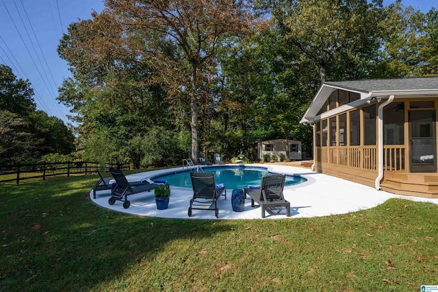 view of pool featuring a yard, a patio, and a sunroom