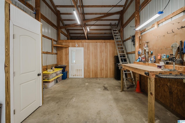 garage with wooden walls and a workshop area