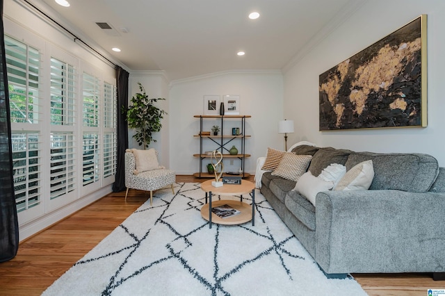 living room featuring crown molding and hardwood / wood-style flooring