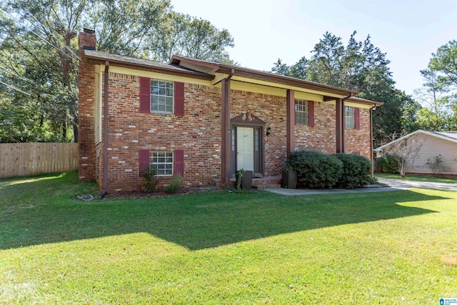 split foyer home with a front lawn