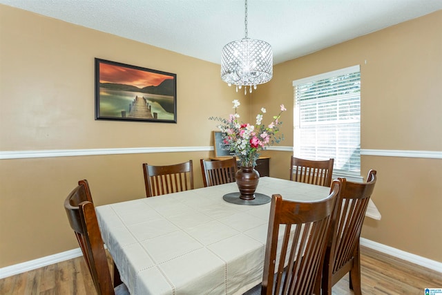 dining room with a chandelier and hardwood / wood-style flooring