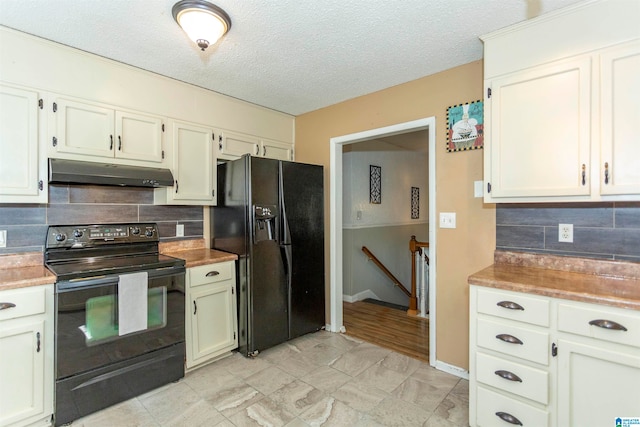 kitchen featuring black appliances, decorative backsplash, a textured ceiling, and white cabinets